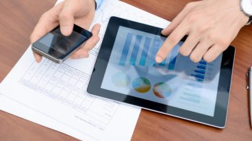 Young businessman working with modern devices.